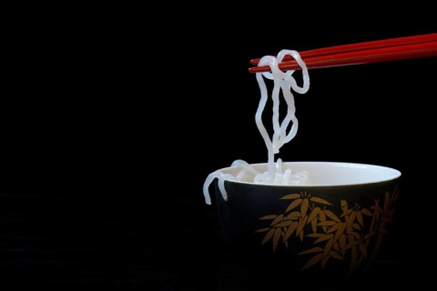 Shirataki noodles made from konjac flour on chopsticks