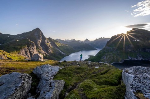 Young woman looking over fjord landscape