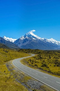 Country road overlooking snow-capped Mount Cook National Park
