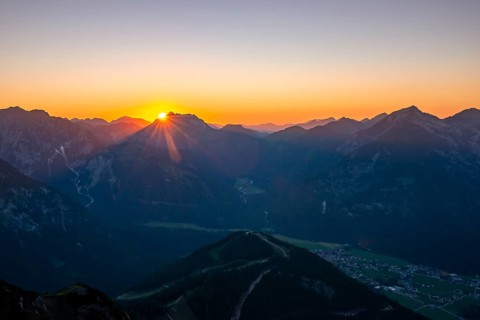 Last rays of sun over mountain landscape at sunset