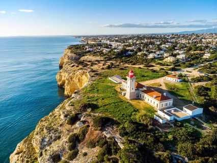 Cliffy coast of Algarve with Alfazinha Lighthouse in Carvoeiro