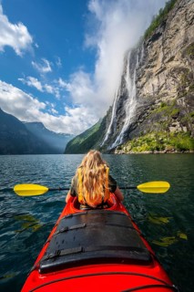 Young woman paddling in a kayak