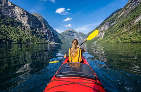 Young woman paddling in a kayak