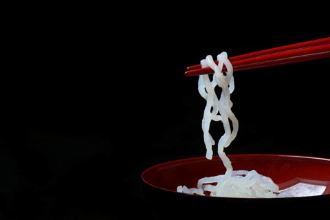 Shirataki noodles made from konjac flour on chopsticks