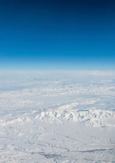 View of mountains and snowy landscape from the airplane