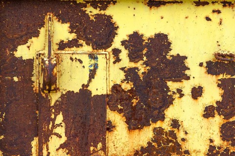 Yellow painted rusty metal plate