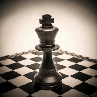 King chess piece on chessboard