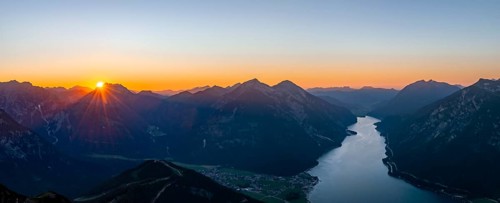 Last rays of sun over mountain landscape at sunset