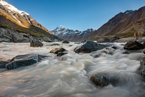 Hooker River in Hooker Valley with view of snow-capped Mount Cook