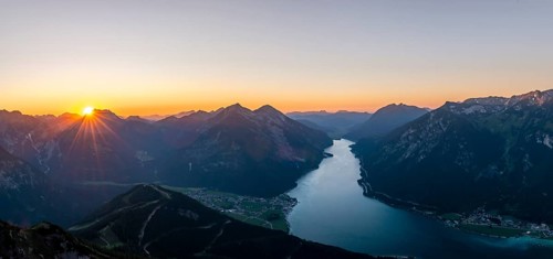 Last rays of sun over mountain landscape at sunset