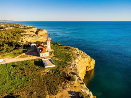 Cliffy coast of Algarve with Alfazinha Lighthouse in Carvoeiro