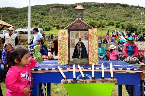 Little indigenous girl looking at a shrine during a folk festival