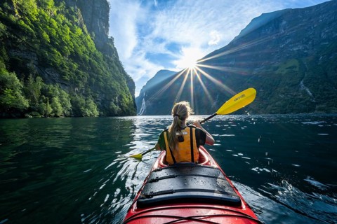 Young woman paddling in a kayak
