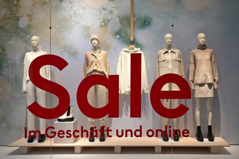 Shop window of a clothing store with the inscription Sale