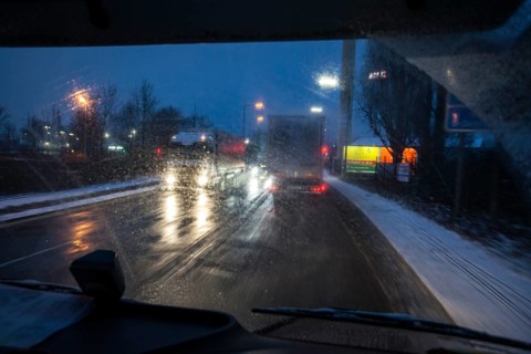 Driving a truck at dawn in winter with poor visibility and road conditions