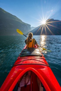 Young woman paddling in a kayak