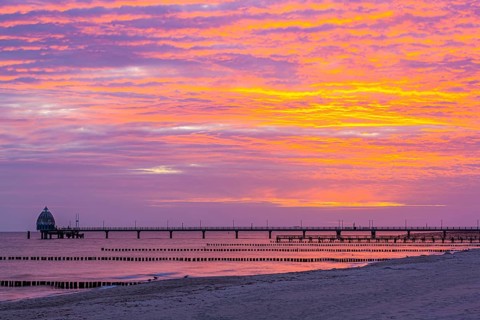 Groyne and diving gondola with pier at the beach of Zingst at sunrise