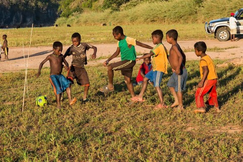 Children playing football at the ferry station across the Manambolo