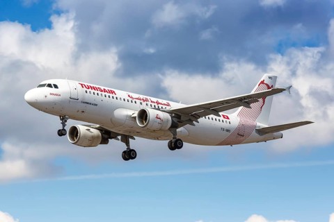 A Tunisair Airbus A320 with the registration TS-IMS lands at London Heathrow Airport