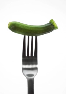 MINIATURE ZUCCHINI OR LONG ZUCCHINI IN MINIATURE AGAINST A WHITE BACKGROUND