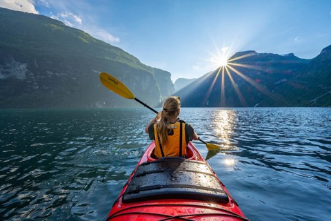 Young woman paddling in a kayak