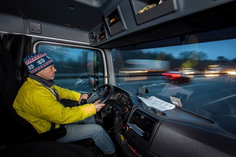 Driving a truck at dawn in winter with poor visibility and road conditions