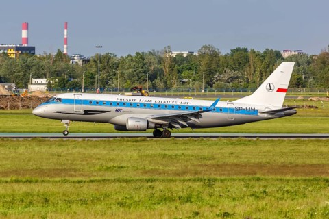 An Embraer 175 of LOT Polskie Linie Lotnicze with the registration SP-LIM in the retro special livery at Warsaw Airport