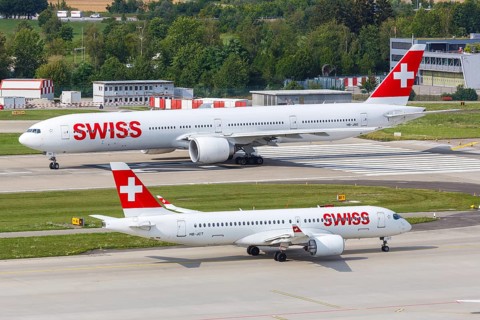 Boeing 777-300ER and Airbus A220-300 aircraft of Swiss at Zurich Airport