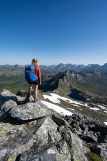 Hiker on the trail to the mountain Rundfjellet