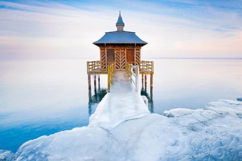 Iced bathhouse at dusk