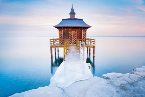 Iced bathhouse at dusk