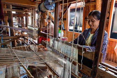 Burmese woman weaving lotus silk