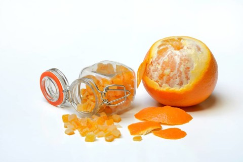 Candied orange peel cubes in glass