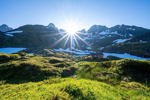 Sun shining on mountains with snow
