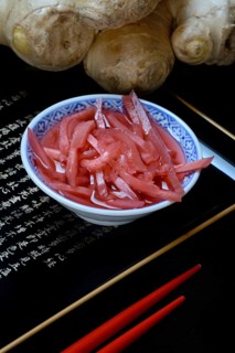 Pickled ginger in small bowls and ginger root