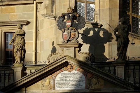 Tympanum or gable above the entrance of the town hall with statues and town coat of arms