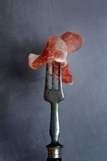 A slice of coppa on fork