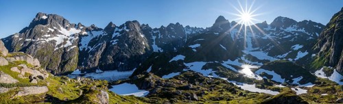 Sun shining on mountains with snow