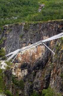 Metal bridge over a rock gorge at Voringfossen waterfall