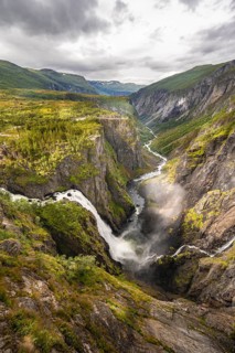 View into the river valley with waterfall Voringfossen