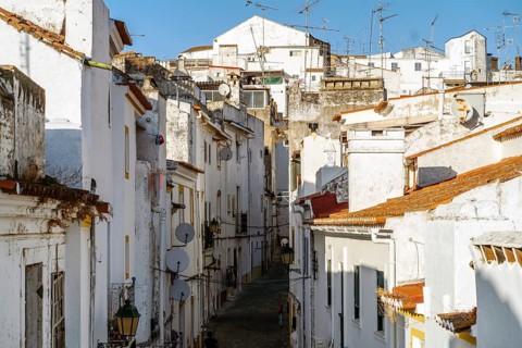 Narrow street between whitewash houses of fortified Elvas