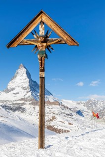 Jesus on wooden cross near Matterhorn