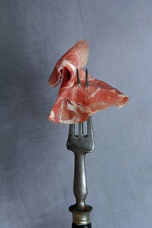 A slice of coppa on fork