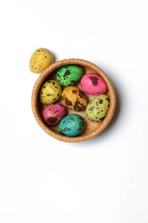 Coloured quail eggs in baskets