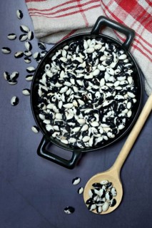 Dried bush beans in pot with cooking spoon