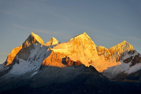 Shining mountain range Nevado Huandoy at sunrise