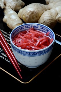 Pickled ginger in small bowls and ginger root