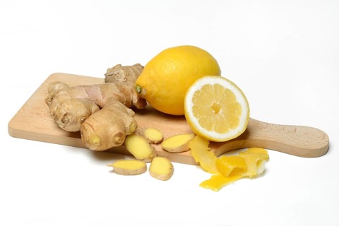 Ginger root and lemon on wooden board