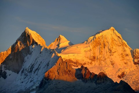 Shining mountain range Nevado Huandoy at sunrise