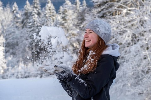 Woman enjoying the snow during winter walk